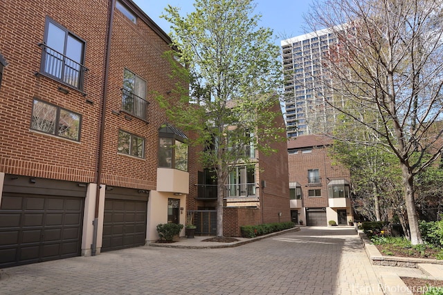 view of property with a garage and driveway