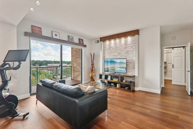 living room featuring visible vents, wood finished floors, and baseboards