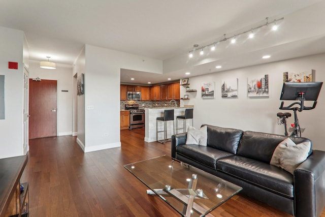 living area with dark wood finished floors, baseboards, and recessed lighting
