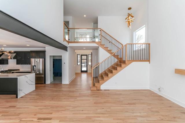 313 Lincoln St, Schaumburg, IL 60194 - entryway with an inviting chandelier, stairway, light wood finished floors, and baseboards