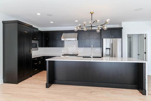 313 Lincoln St, Schaumburg, IL 60194 - kitchen featuring extractor fan, appliances with stainless steel finishes, light countertops, and a sink