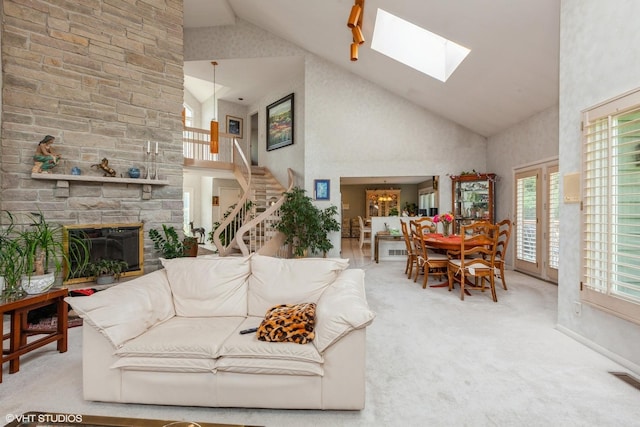 18W742 60th St, Westmont, IL 60559 - living area featuring a skylight, carpet floors, stairway, a stone fireplace, and high vaulted ceiling