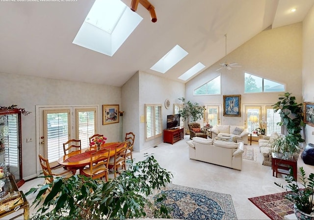 18W742 60th St, Westmont, IL 60559 - living area featuring high vaulted ceiling, ceiling fan, light carpet, baseboards, and a skylight