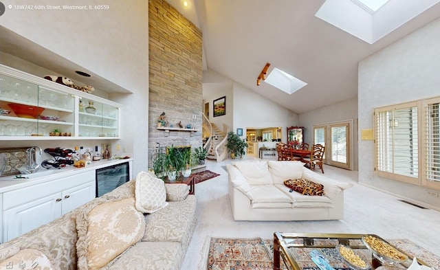 18W742 60th St, Westmont, IL 60559 - living area with carpet flooring, wine cooler, high vaulted ceiling, visible vents, and a skylight