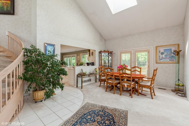 18W742 60th St, Westmont, IL 60559 - carpeted dining space with visible vents, stairway, a skylight, and high vaulted ceiling