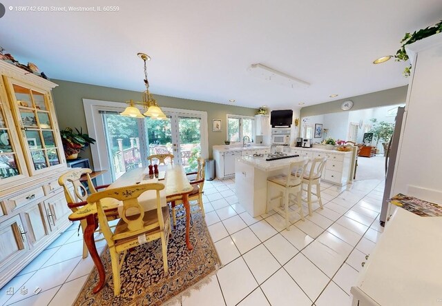 18W742 60th St, Westmont, IL 60559 - dining room with light tile patterned floors, french doors, and recessed lighting
