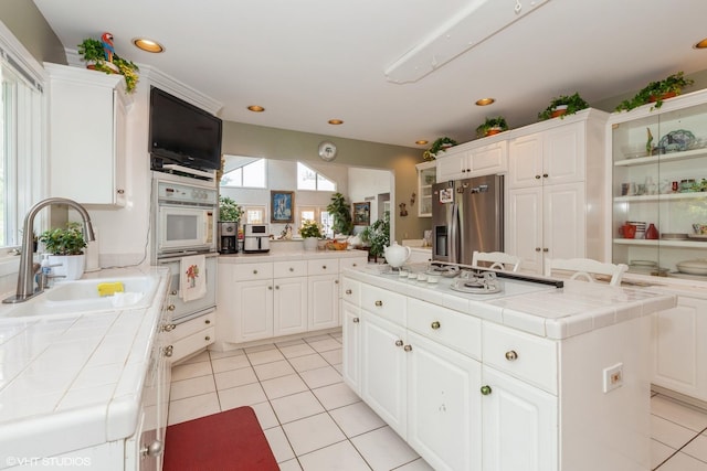 18W742 60th St, Westmont, IL 60559 - kitchen featuring a sink, light tile patterned floors, stainless steel refrigerator with ice dispenser, tile countertops, and white cooktop