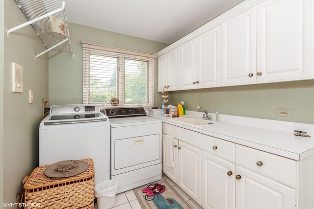 18W742 60th St, Westmont, IL 60559 - laundry area featuring washing machine and dryer, light tile patterned floors, cabinet space, and a sink