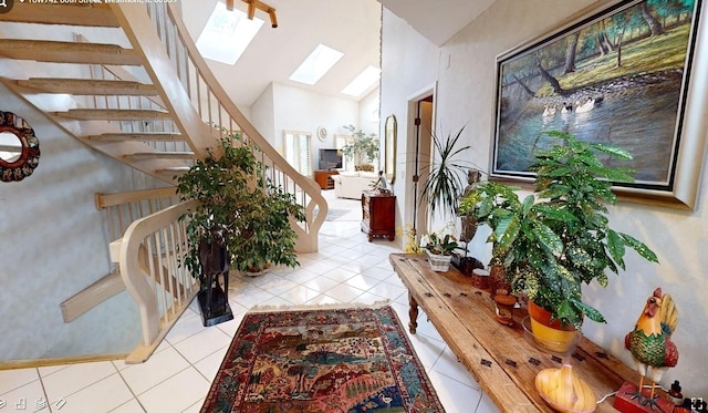 18W742 60th St, Westmont, IL 60559 - entrance foyer featuring a skylight, high vaulted ceiling, tile patterned flooring, and stairs
