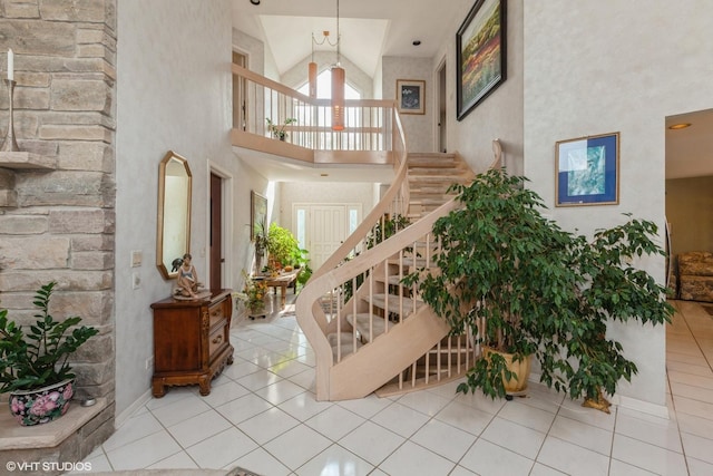 18W742 60th St, Westmont, IL 60559 - tiled foyer with high vaulted ceiling, an inviting chandelier, and stairway