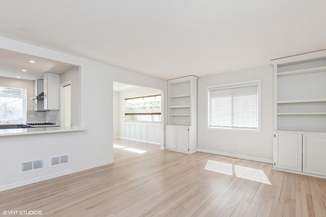 127 Riverside Dr, Northfield, IL 60093 - unfurnished living room with light wood-style floors, visible vents, built in features, and baseboards