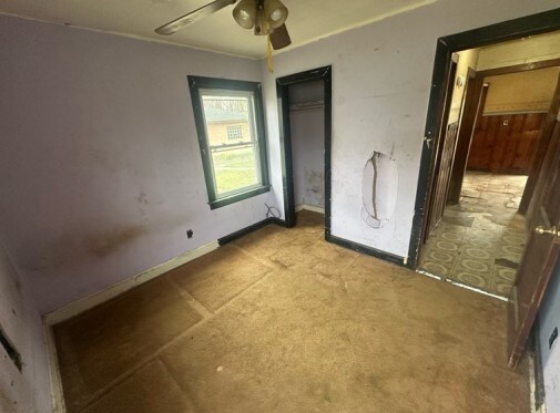 14717 E Riverside Dr, South Holland, IL 60473 - unfurnished bedroom featuring light carpet, a closet, baseboards, and a ceiling fan