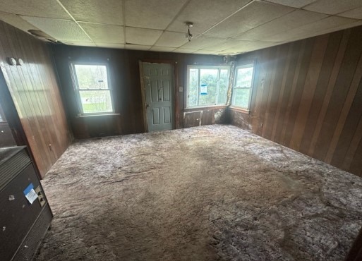 14717 E Riverside Dr, South Holland, IL 60473 - empty room with carpet, wood walls, and a paneled ceiling