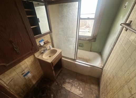 14717 E Riverside Dr, South Holland, IL 60473 - full bathroom with a shower with door, vanity, and tile walls