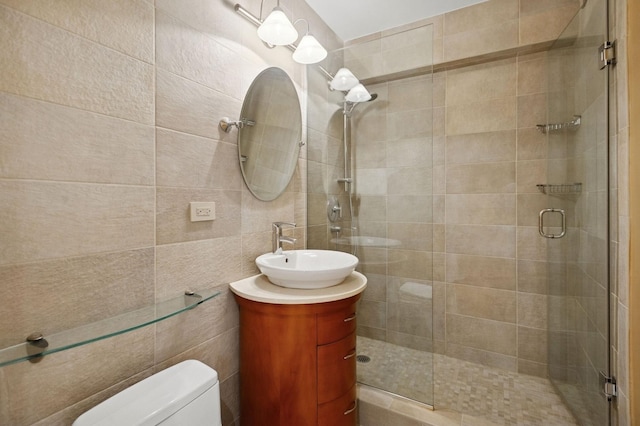 247 E Chestnut St Unit 2303, Chicago, IL 60611 - bathroom with toilet, a stall shower, vanity, and tile walls