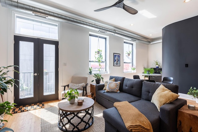living area with visible vents, wood finished floors, recessed lighting, french doors, and a ceiling fan
