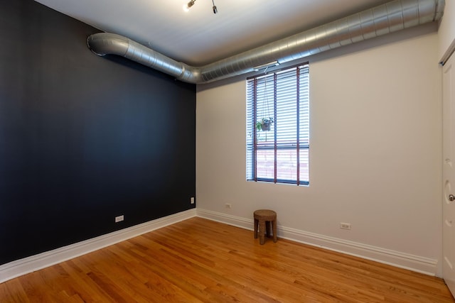 unfurnished room with light wood-style floors and baseboards
