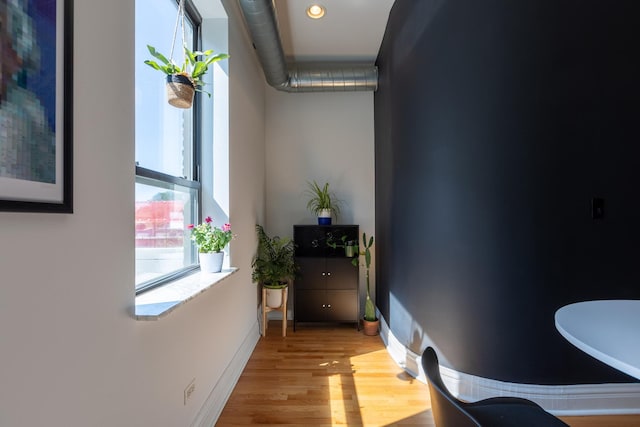 hallway with recessed lighting, baseboards, and wood finished floors