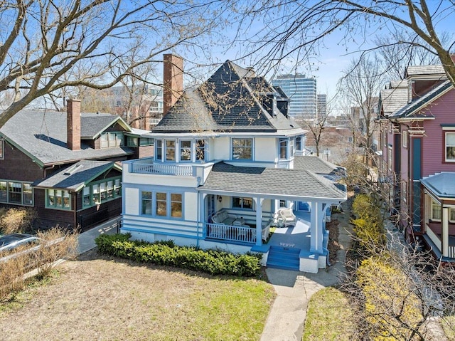 1833 Asbury Ave, Evanston, IL 60201 - view of front of home with covered porch, a chimney, and a shingled roof