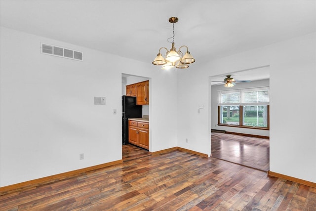 2506 S Cottage Grove Ave, Urbana, IL 61801 - empty room featuring a chandelier, dark wood-style floors, ceiling fan, and baseboards