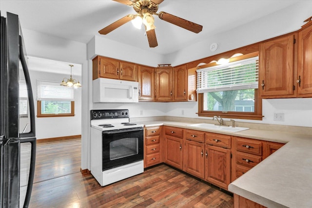 2506 S Cottage Grove Ave, Urbana, IL 61801 - kitchen featuring electric range, white microwave, a sink, freestanding refrigerator, and plenty of natural light