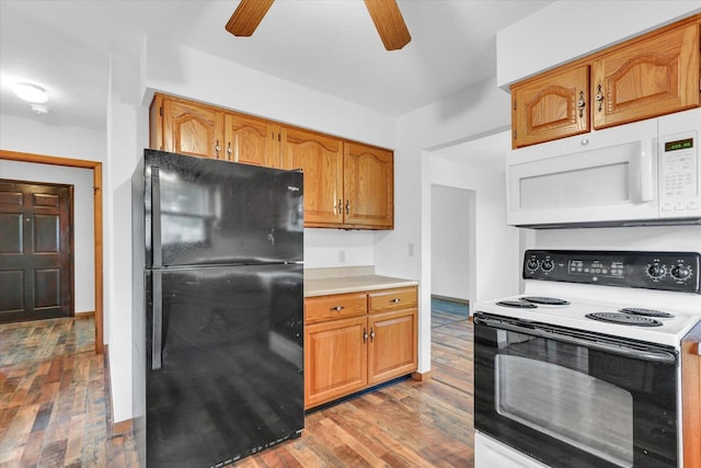 2506 S Cottage Grove Ave, Urbana, IL 61801 - kitchen featuring freestanding refrigerator, range with electric cooktop, white microwave, a ceiling fan, and wood finished floors