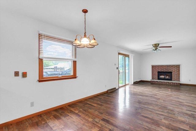 2506 S Cottage Grove Ave, Urbana, IL 61801 - unfurnished living room featuring wood finished floors, baseboards, and a chandelier