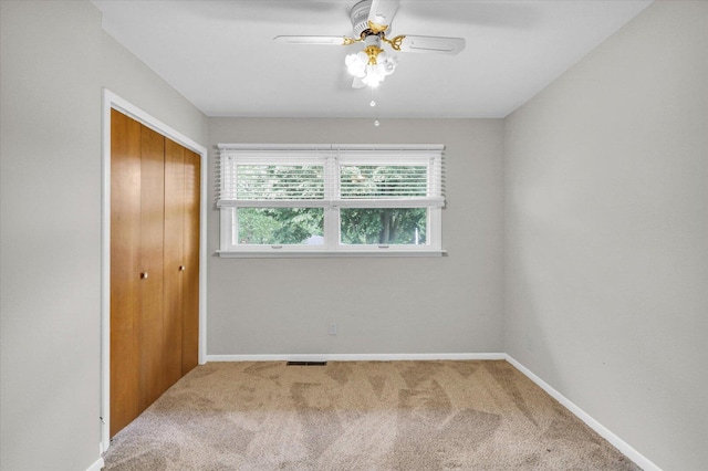 2506 S Cottage Grove Ave, Urbana, IL 61801 - unfurnished bedroom featuring carpet floors, a closet, baseboards, and ceiling fan
