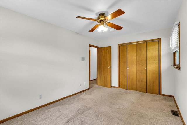 2506 S Cottage Grove Ave, Urbana, IL 61801 - unfurnished bedroom featuring carpet flooring, a closet, baseboards, and a ceiling fan