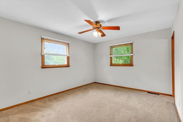 2506 S Cottage Grove Ave, Urbana, IL 61801 - empty room featuring carpet floors, baseboards, and a ceiling fan