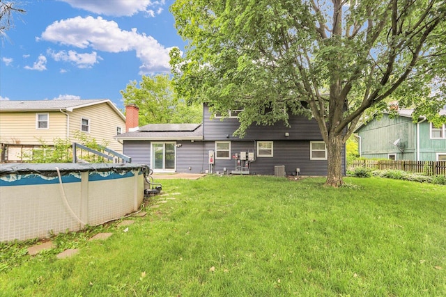 2506 S Cottage Grove Ave, Urbana, IL 61801 - back of property with roof mounted solar panels, a covered pool, and central AC unit