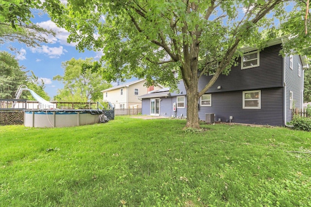 2506 S Cottage Grove Ave, Urbana, IL 61801 - view of yard featuring central AC unit and an outdoor pool