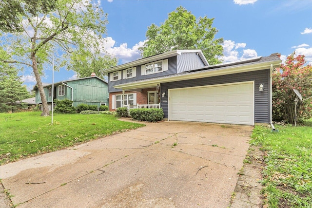 2506 S Cottage Grove Ave, Urbana, IL 61801 - view of front facade featuring a front yard, a garage, and driveway