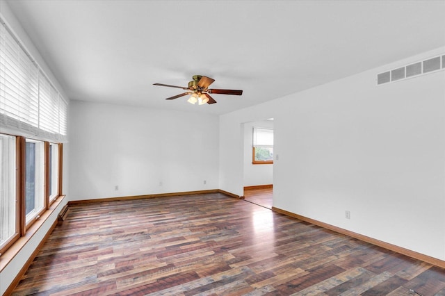 2506 S Cottage Grove Ave, Urbana, IL 61801 - unfurnished room with wood finished floors, a ceiling fan, and baseboards