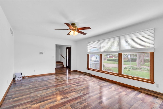 2506 S Cottage Grove Ave, Urbana, IL 61801 - empty room featuring wood finished floors, ceiling fan, baseboards, and stairs
