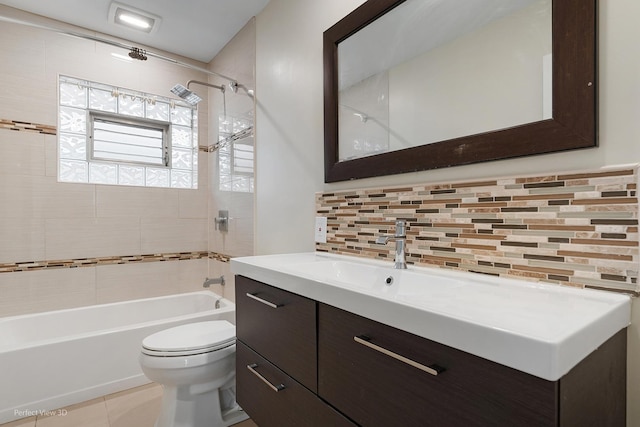 bathroom featuring decorative backsplash, tile patterned flooring, vanity, toilet, and bathing tub / shower combination