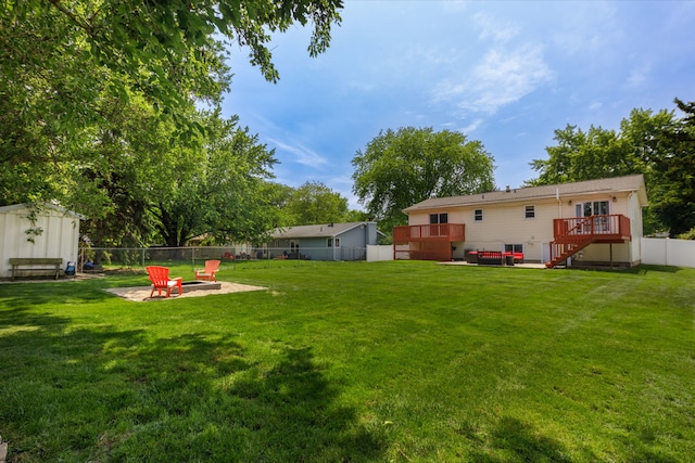 24221 S Edwin Dr, Channahon, IL 60410 - fenced backyard featuring a fire pit, a deck, a storage unit, stairs, and a patio