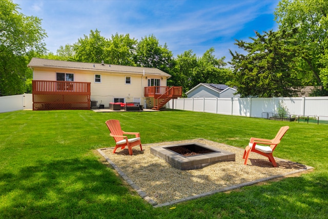 24221 S Edwin Dr, Channahon, IL 60410 - fenced backyard with an outdoor fire pit, a wooden deck, stairway, and a patio