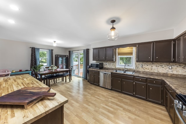24221 S Edwin Dr, Channahon, IL 60410 - kitchen featuring stainless steel appliances, dark brown cabinetry, backsplash, light wood-style floors, and decorative light fixtures