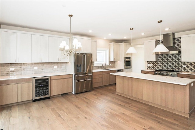 kitchen with tasteful backsplash, stainless steel appliances, a sink, wall chimney exhaust hood, and wine cooler