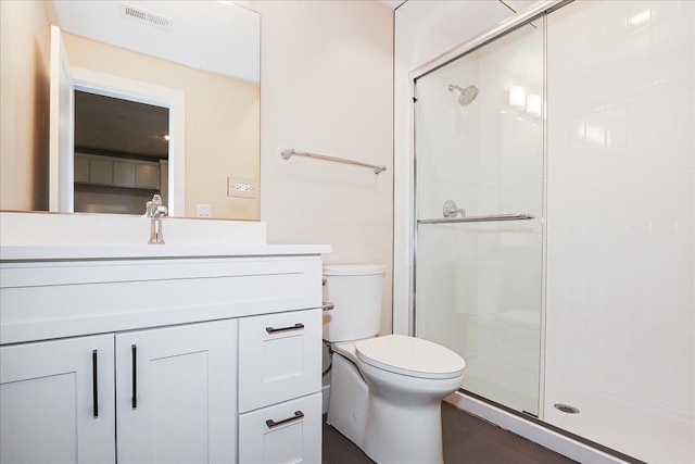 full bathroom with visible vents, a stall shower, toilet, and vanity
