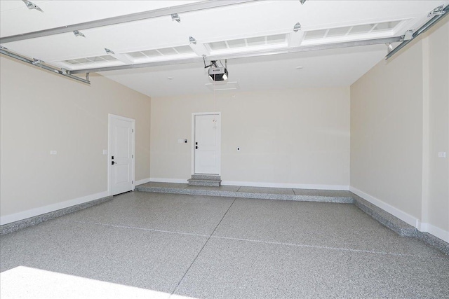 garage with a garage door opener and baseboards
