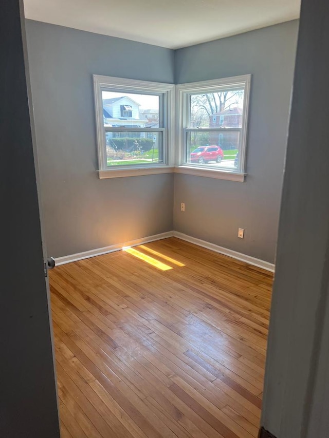 12408 S Carpenter St, Calumet Park, IL 60827 - empty room with baseboards, a wealth of natural light, and hardwood / wood-style floors