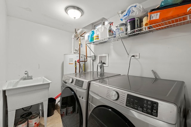 washroom with water heater, separate washer and dryer, and laundry area