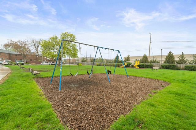 community jungle gym with fence and a yard