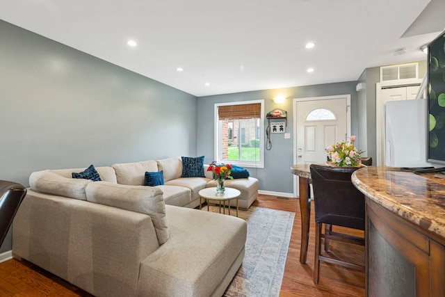 living area with visible vents, recessed lighting, dark wood finished floors, and baseboards