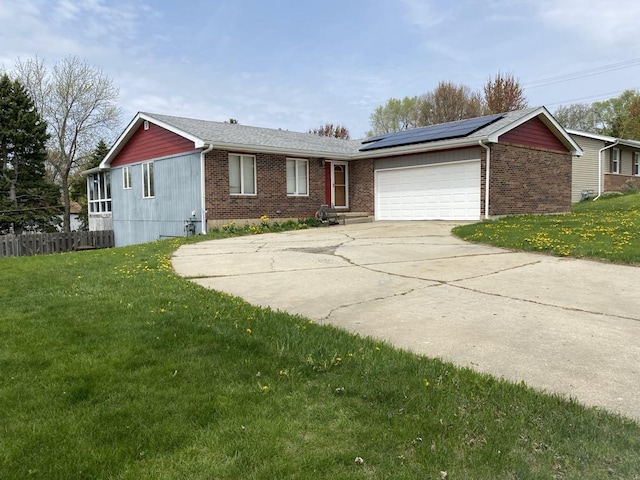 10607 Mathew St, Huntley, IL 60142 - ranch-style house featuring an attached garage, concrete driveway, solar panels, and brick siding