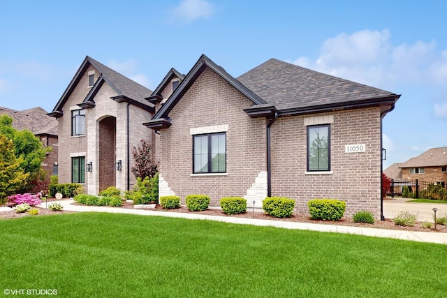 11050 Deer Haven Ln, Orland Park, IL 60467 - french country inspired facade featuring brick siding, a front yard, and roof with shingles