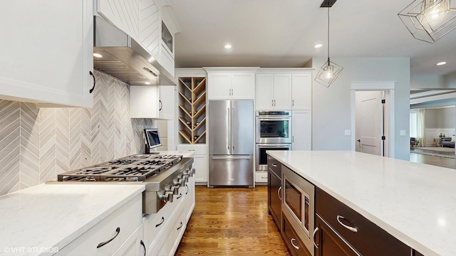 11050 Deer Haven Ln, Orland Park, IL 60467 - kitchen with stainless steel appliances, wall chimney range hood, backsplash, decorative light fixtures, and white cabinets