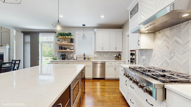 11050 Deer Haven Ln, Orland Park, IL 60467 - kitchen featuring appliances with stainless steel finishes, extractor fan, backsplash, pendant lighting, and a sink